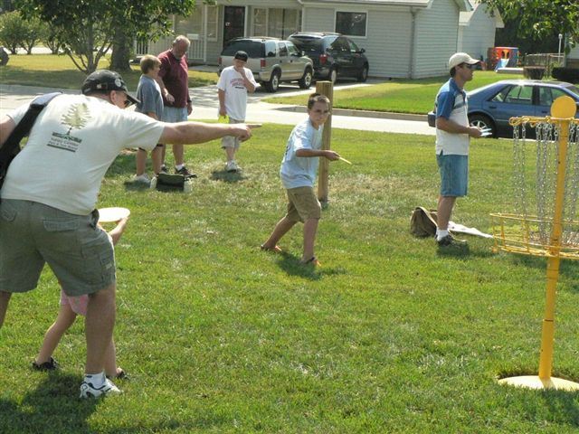 A man plays frisbee with a child